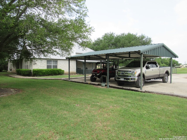 view of parking / parking lot featuring a carport and a yard