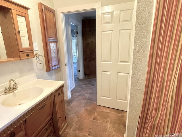 bathroom with tile floors and vanity with extensive cabinet space