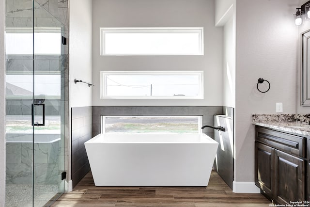 bathroom with vanity, separate shower and tub, and wood-type flooring