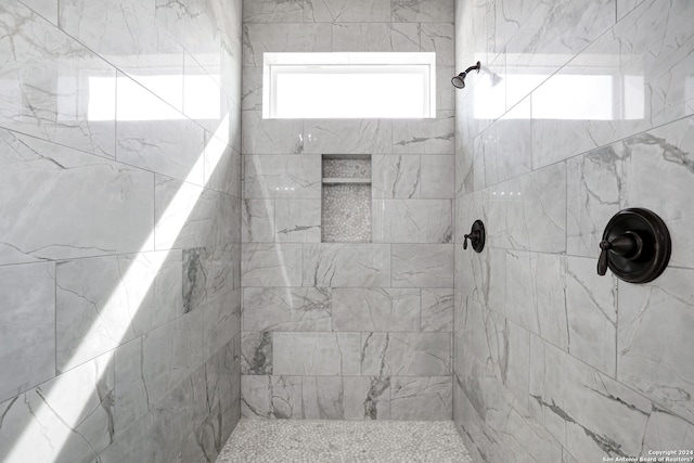 bathroom with tiled shower