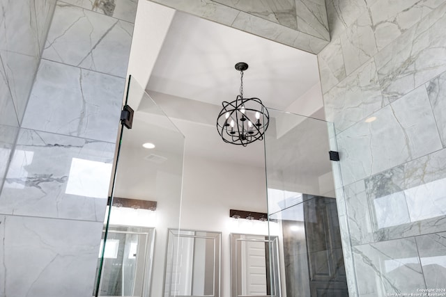 interior details with a notable chandelier and walk in shower