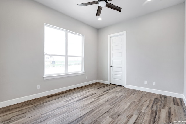 empty room with light wood-type flooring and ceiling fan