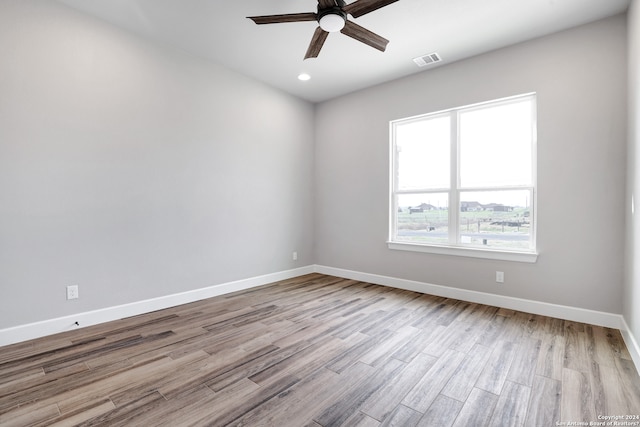 spare room with ceiling fan and light hardwood / wood-style flooring