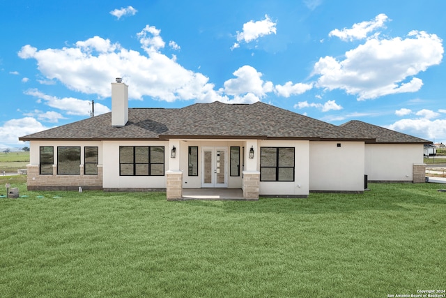 back of property featuring a yard and french doors