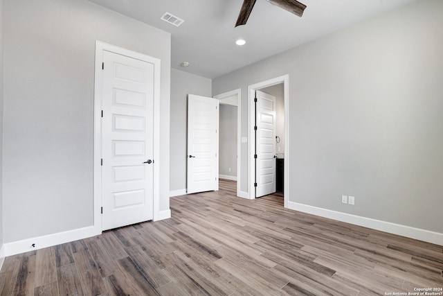 unfurnished bedroom with ceiling fan and light hardwood / wood-style floors