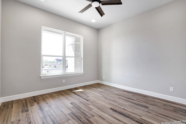 empty room with ceiling fan and light hardwood / wood-style floors