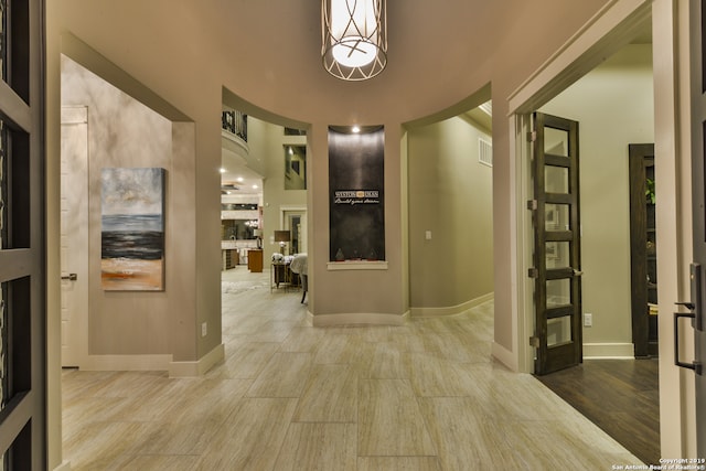 corridor with light hardwood / wood-style floors