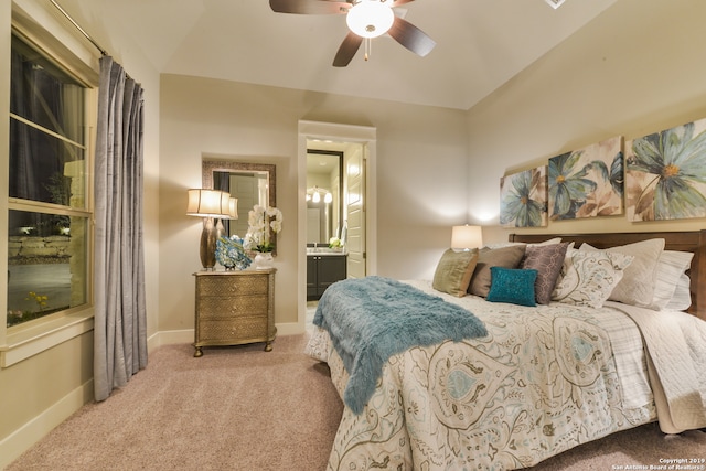 bedroom featuring light carpet, ceiling fan, and ensuite bathroom