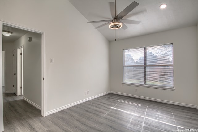 empty room featuring lofted ceiling, ceiling fan, and wood-type flooring