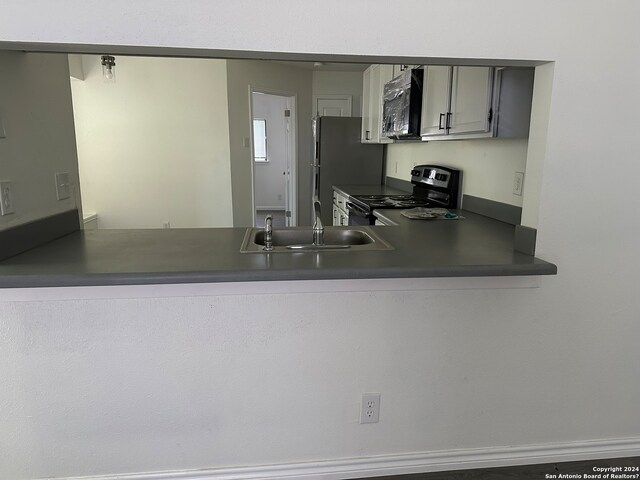 kitchen with gray cabinetry, sink, and black appliances