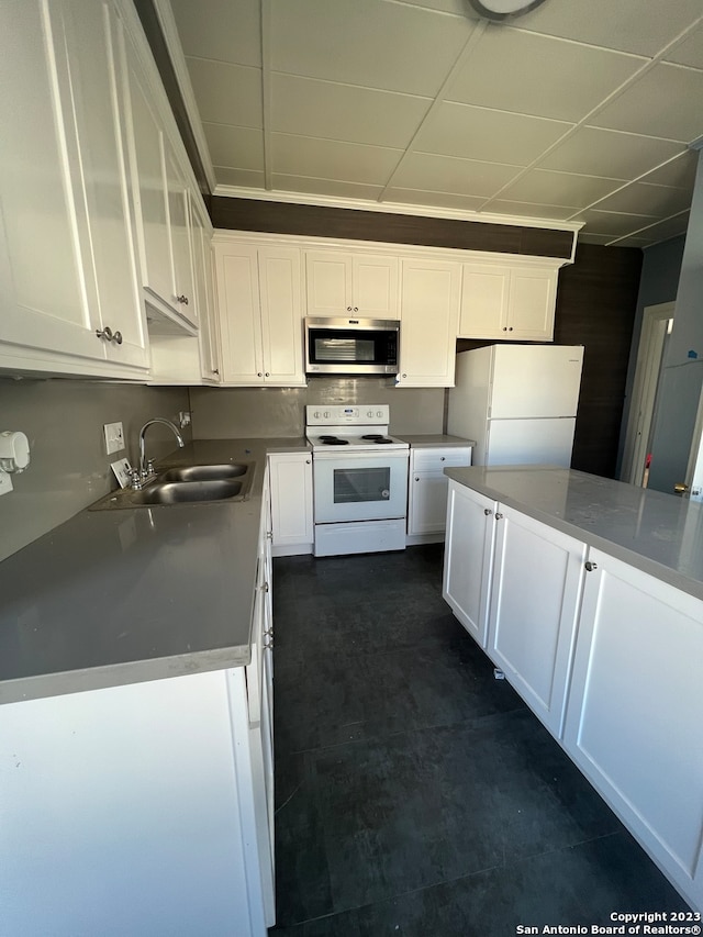 kitchen featuring white cabinets, white appliances, and sink