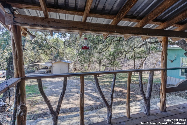 wooden deck featuring a shed