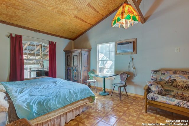 bedroom featuring light parquet floors, a wall mounted AC, wood ceiling, and vaulted ceiling