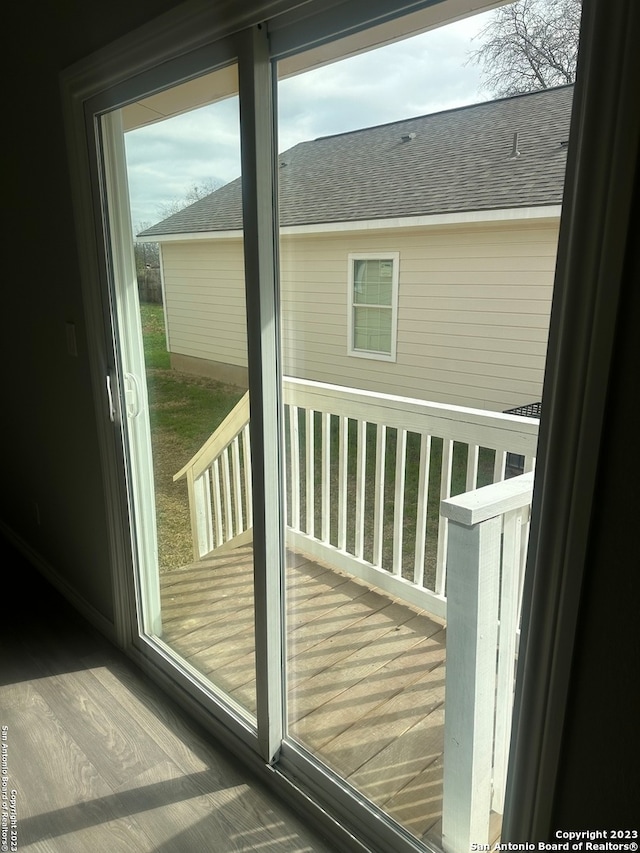 doorway with dark hardwood / wood-style flooring and a healthy amount of sunlight