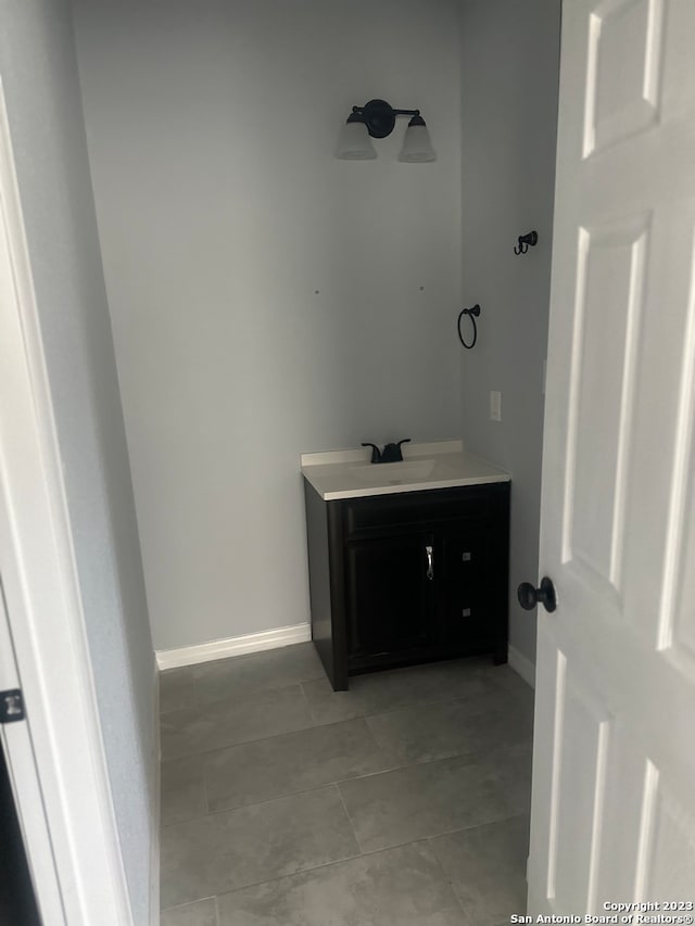 bathroom with tile flooring and vanity