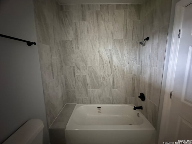 bathroom with tub / shower combination and toilet