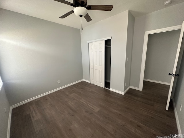 unfurnished bedroom with a closet, ceiling fan, and dark hardwood / wood-style flooring