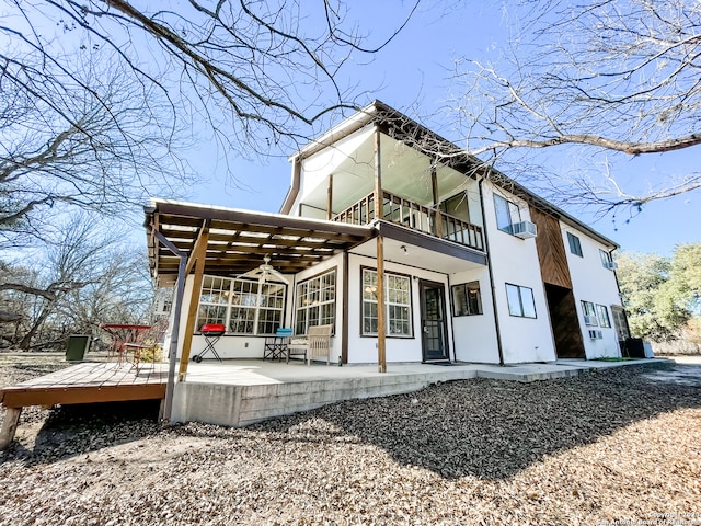 rear view of house with a balcony, a pergola, and a patio area