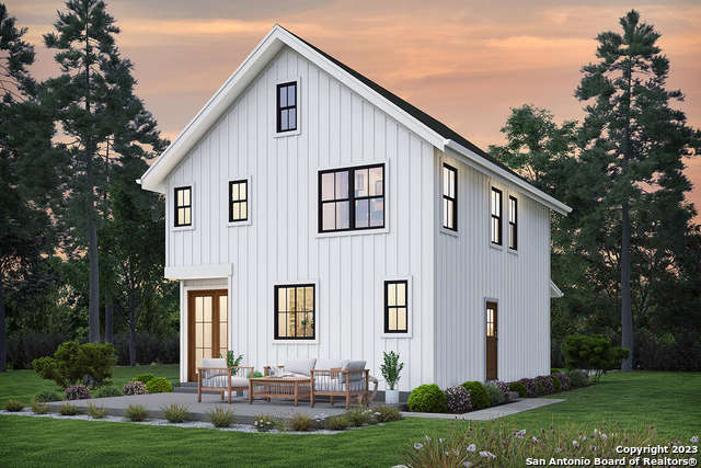 back house at dusk featuring an outdoor living space and a yard