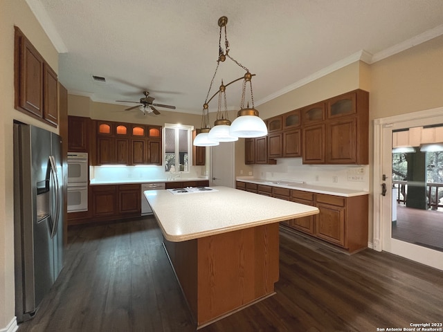 119 Cedar Tree Ln, Canyon Lake, TX 78133 - kitchen with ceiling fan, dark wood-type flooring, appliances with stainless steel finishes, and a center island