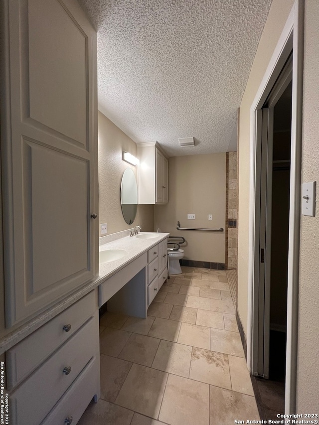 119 Cedar Tree Ln, Canyon Lake, TX 78133 - bathroom with toilet, tile flooring, a textured ceiling, and vanity