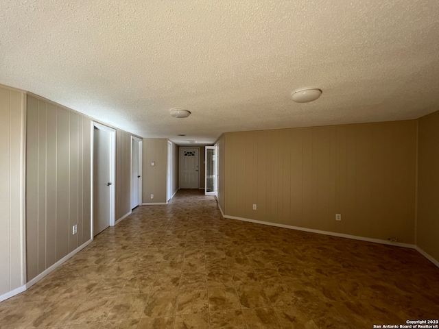 119 Cedar Tree Ln, Canyon Lake, TX 78133 - spare room with dark tile flooring and a textured ceiling