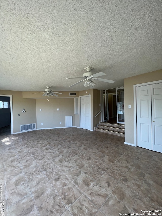 119 Cedar Tree Ln, Canyon Lake, TX 78133 - tiled spare room with ceiling fan and a textured ceiling