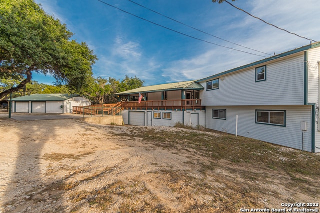 119 Cedar Tree Ln, Canyon Lake, TX 78133 - back of house featuring an outdoor structure and a garage