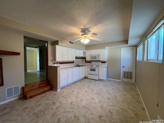 119 Cedar Tree Ln, Canyon Lake, TX 78133 - kitchen featuring light tile floors, ceiling fan, a textured ceiling, white appliances, and white cabinetry