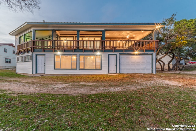 119 Cedar Tree Ln, Canyon Lake, TX 78133 - view of front of home featuring a balcony, a front lawn, and a garage