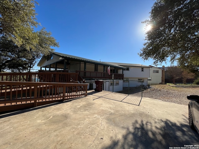 119 Cedar Tree Ln, Canyon Lake, TX 78133 - rear view of house with a wooden deck and a garage