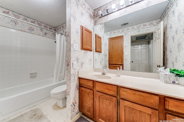 full bathroom with toilet, vanity with extensive cabinet space, tile floors, shower / tub combo with curtain, and a textured ceiling