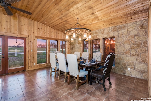 tiled dining room featuring wooden ceiling, high vaulted ceiling, and ceiling fan with notable chandelier