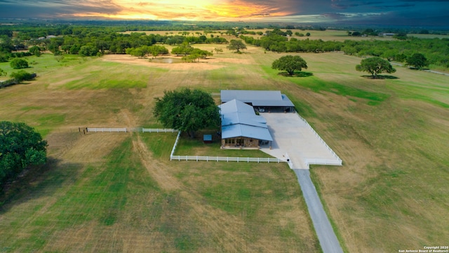 aerial view at dusk featuring a rural view