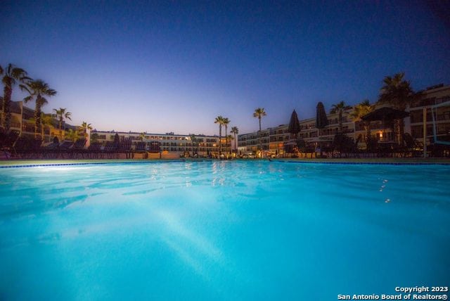 view of pool at dusk