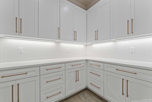 kitchen with white cabinetry, tasteful backsplash, and light hardwood / wood-style flooring