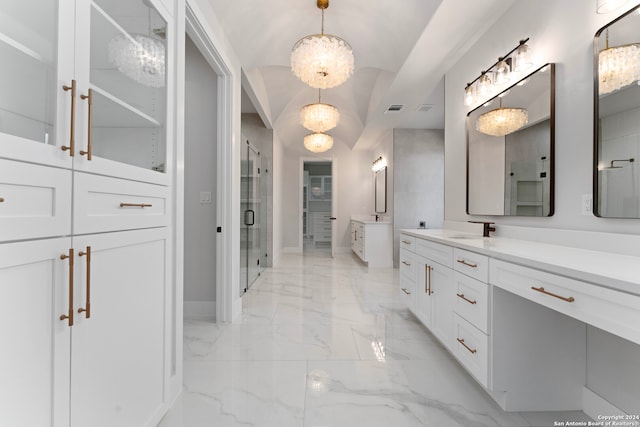 bathroom featuring a notable chandelier, vanity, and an enclosed shower