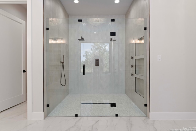 bathroom with a shower with door