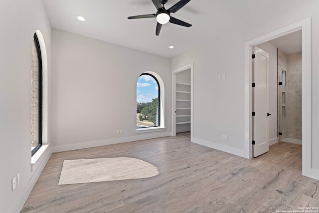 empty room featuring ceiling fan and light hardwood / wood-style floors