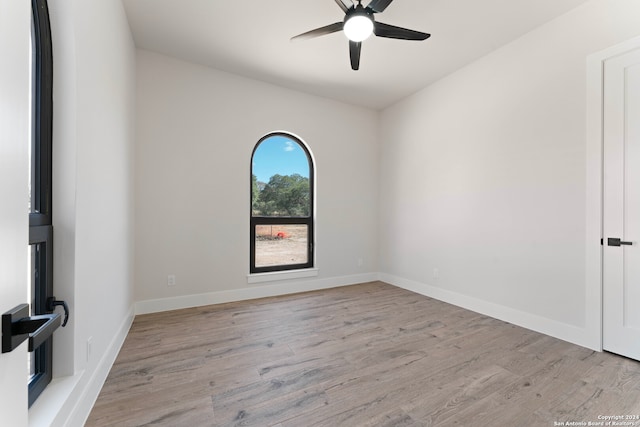 spare room with light wood-type flooring and ceiling fan