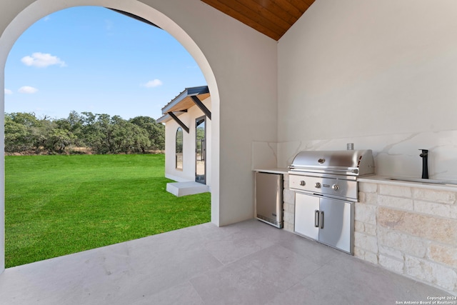 view of patio with a grill, exterior kitchen, and sink