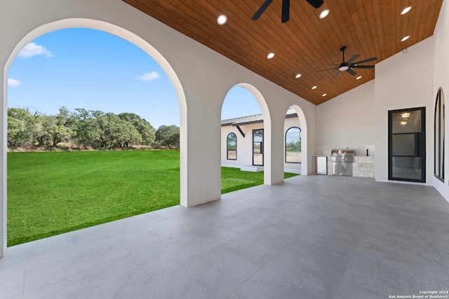 view of patio / terrace with an outdoor kitchen, ceiling fan, and grilling area