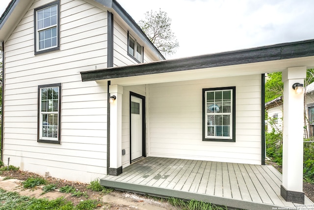 rear view of property featuring a deck