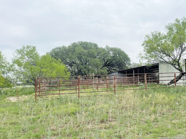 view of yard featuring a rural view and an outdoor structure