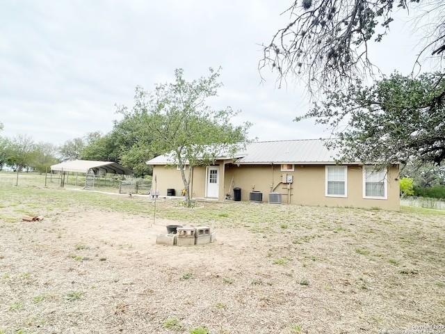 rear view of property featuring central AC