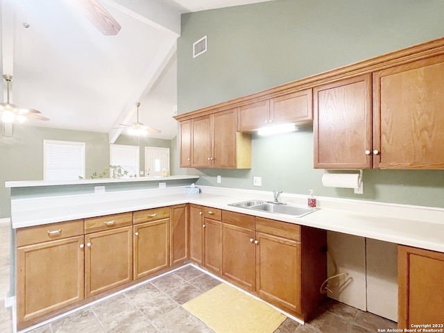 kitchen featuring kitchen peninsula, ceiling fan, light tile floors, and sink