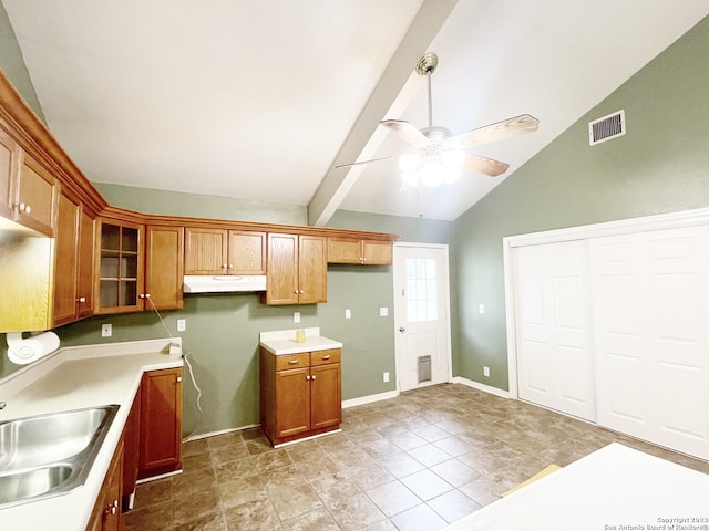 kitchen featuring ceiling fan, beamed ceiling, high vaulted ceiling, sink, and light tile floors