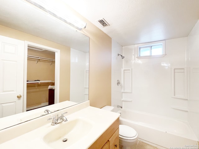 full bathroom featuring toilet, oversized vanity, shower / bath combination, a textured ceiling, and tile floors