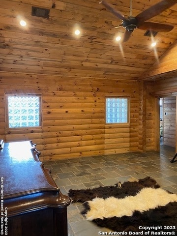 unfurnished bedroom with lofted ceiling, log walls, dark tile floors, and wooden ceiling