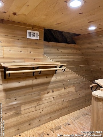 view of sauna / steam room featuring wooden walls and wood ceiling